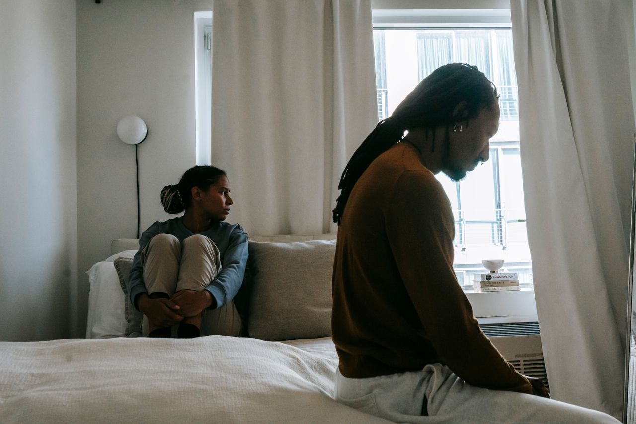 Crafting Captivating Headlines: Your awesome post title goes here Young frustrated black man with dreadlocks near unhappy girlfriend sitting on bed during conflict